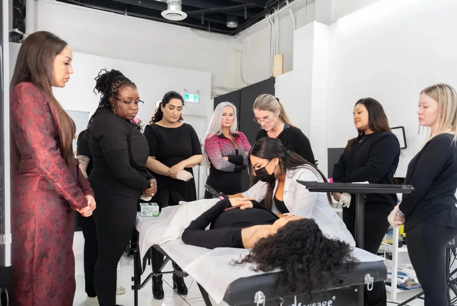 Students gathered around a live model during a demonstration in the Wholesome Empire studio